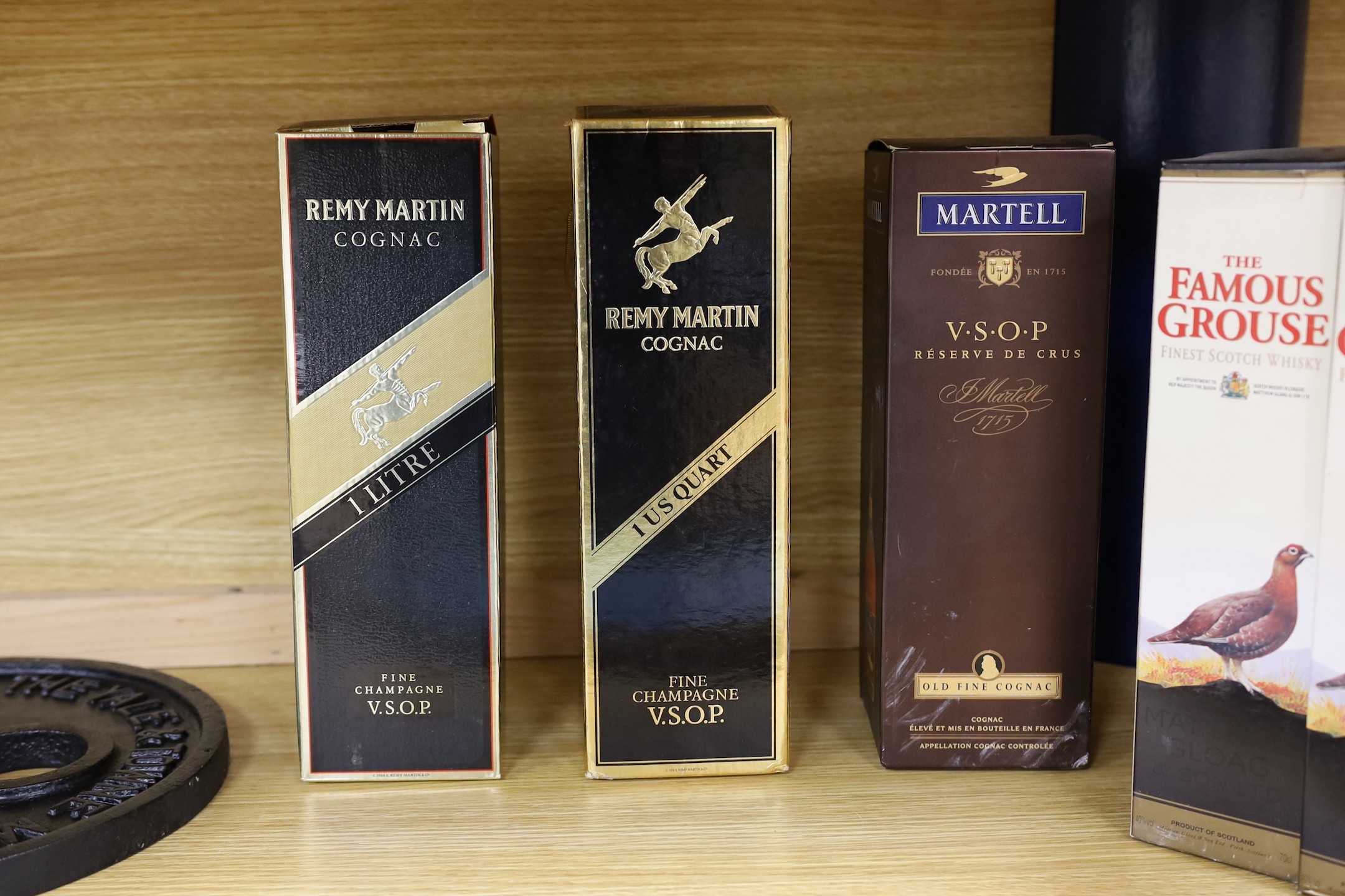 Six various bottles of cognac and whisky, to include two 1 litre boxed bottles of Remy Martin cognac, a boxed 1 litre bottle of Martell cognac, and three boxed 70cl bottles of The Famous Grouse whisky